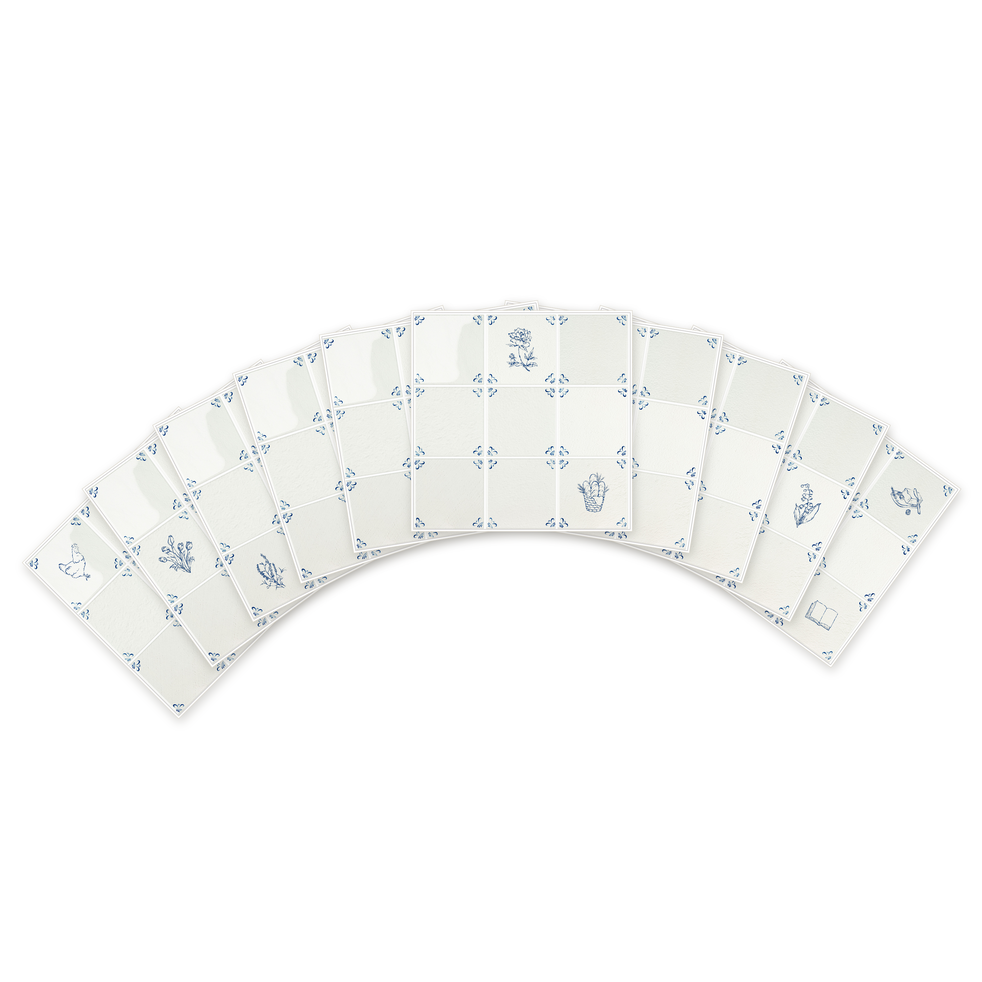 Ten Akka Home peel and stick Delft tiles fanned on white showing pre-printed motifs — chicken, tulips, lavender, peony and lily of the valley in Dutch Blue